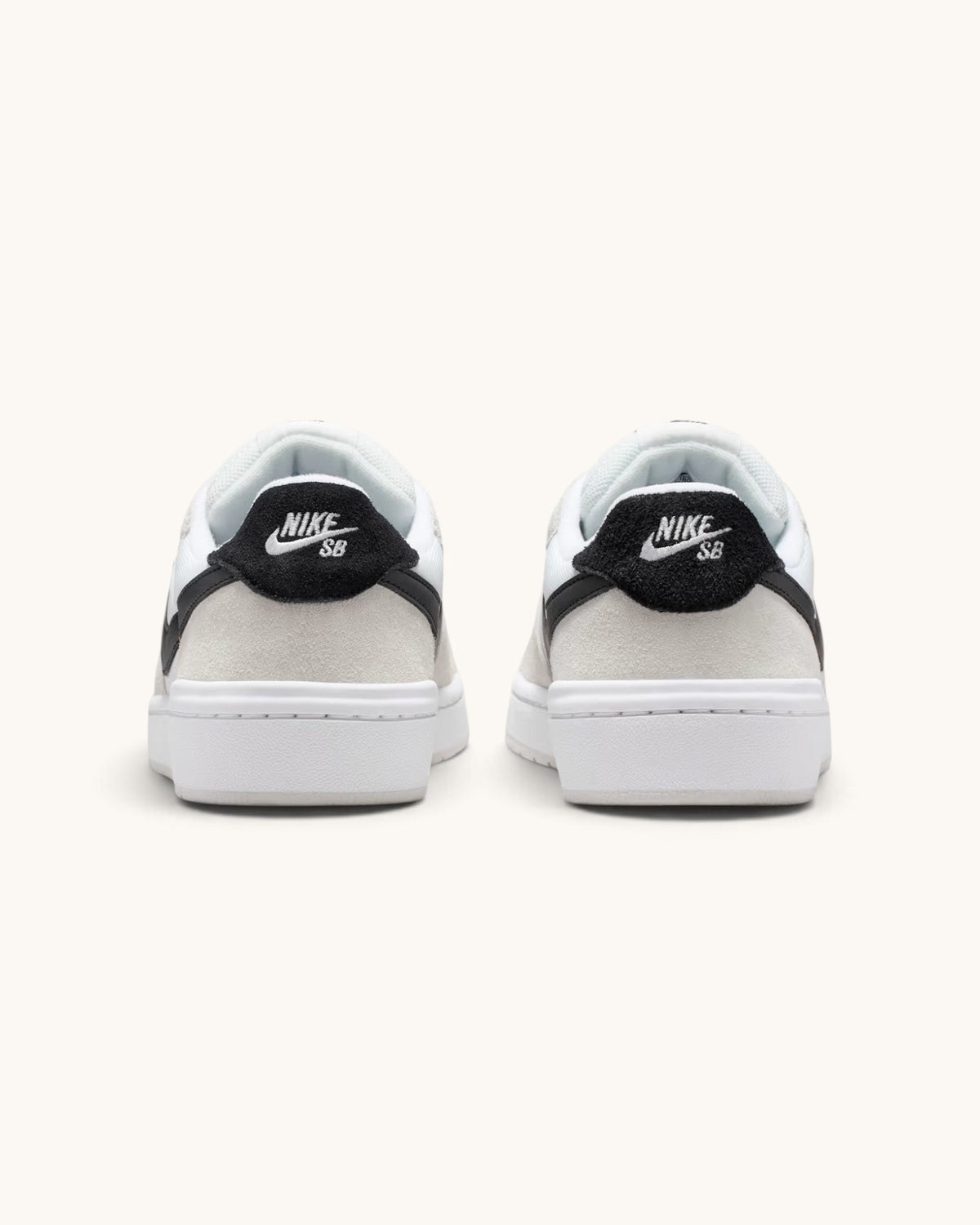 FRIDAY.COM.CO Nike SB Code 58 sneakers in summit white with black heel tabs and cupsole construction, rear view.