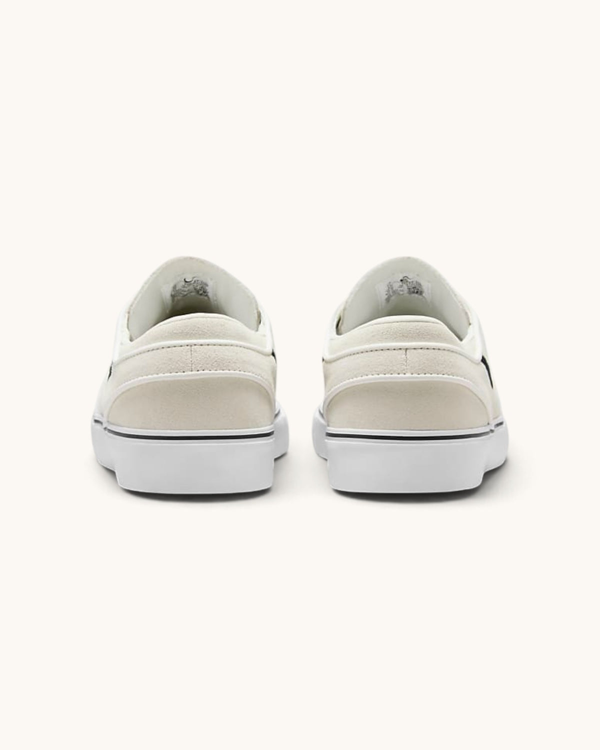 FRIDAY.COM.CO Nike SB Zoom Janoski OG+ skate shoes in off-white suede, rear view showing vulcanized rubber soles.