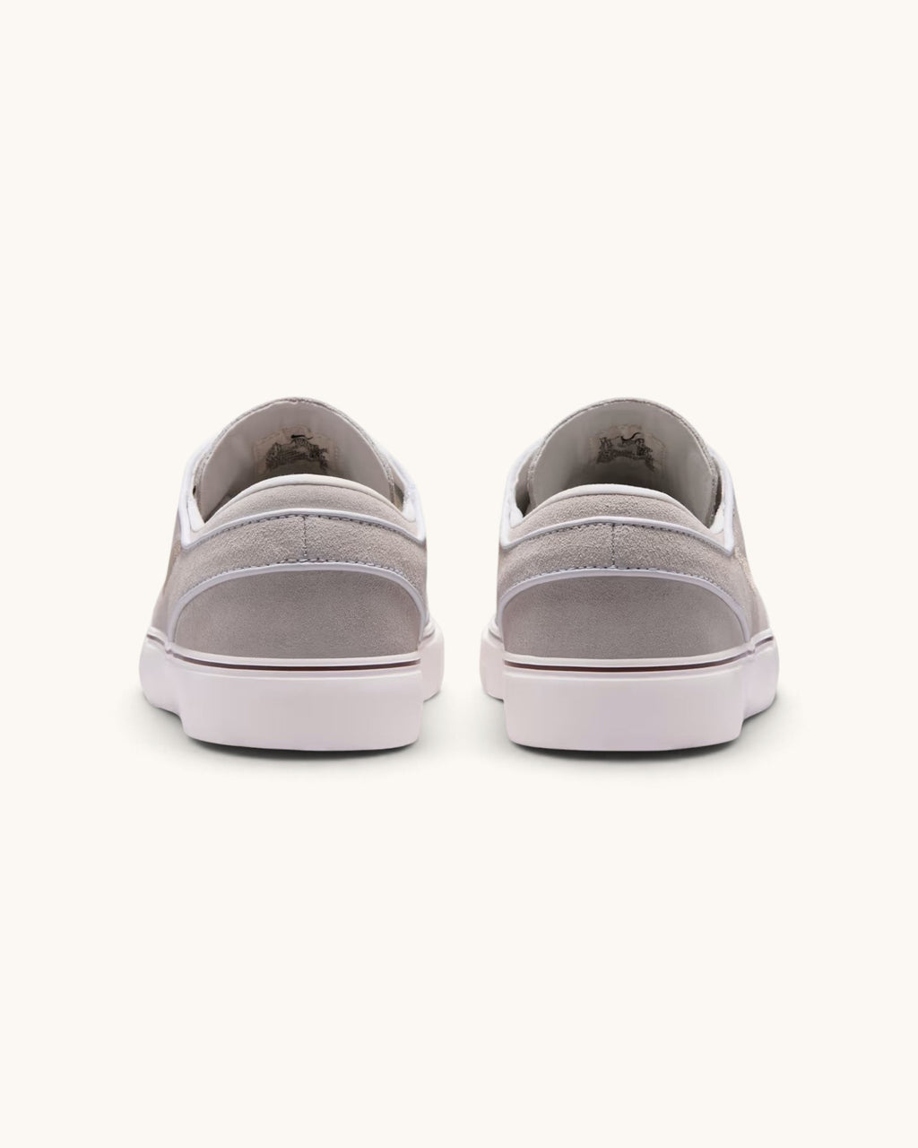 FRIDAY.COM.CO Nike SB Zoom Janoski OG+ sneakers in light linen suede, rear view showing vulcanized white soles.