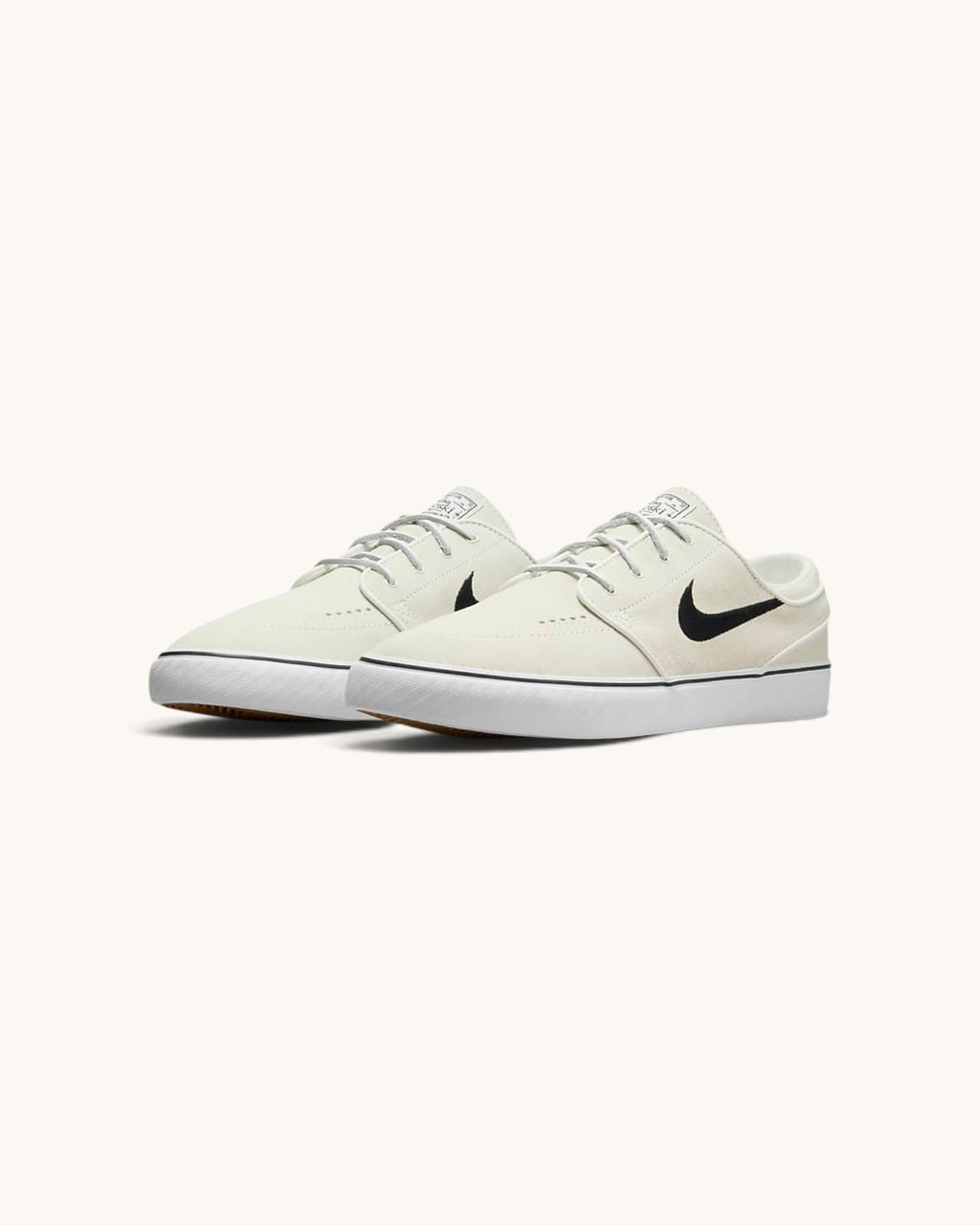 FRIDAY.COM.CO Nike SB Zoom Janoski OG+ skate shoes in off-white suede with a black Swoosh and vulcanized rubber sole.