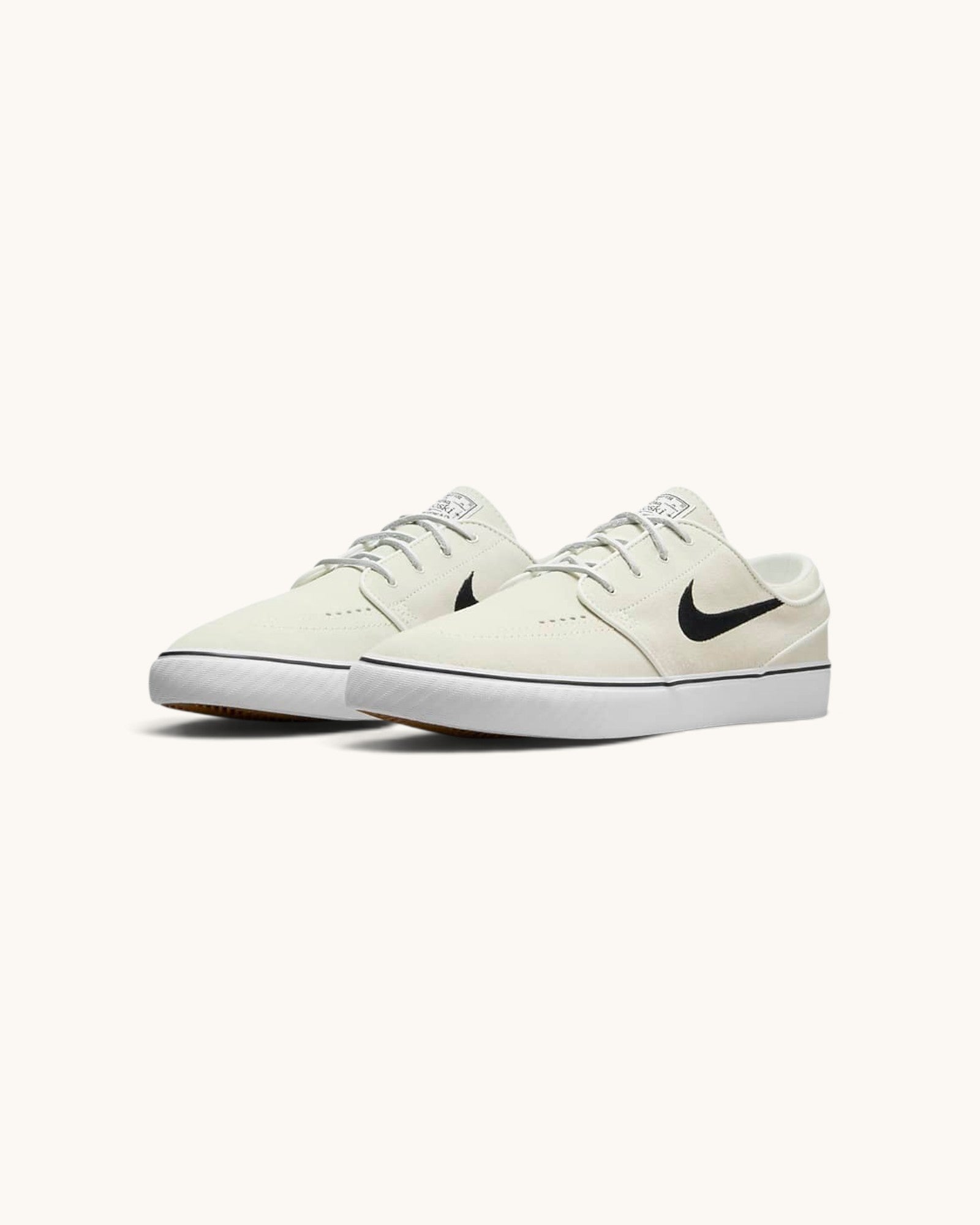 FRIDAY.COM.CO Nike SB Zoom Janoski OG+ skate shoes in off-white suede with a black Swoosh and vulcanized rubber sole.