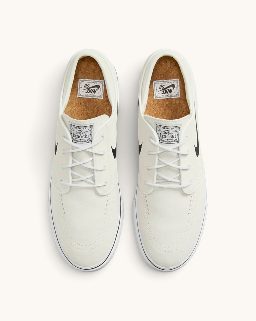 FRIDAY.COM.CO Nike SB Zoom Janoski OG+ skate shoes in off-white suede with black Swoosh and cork insoles, top view