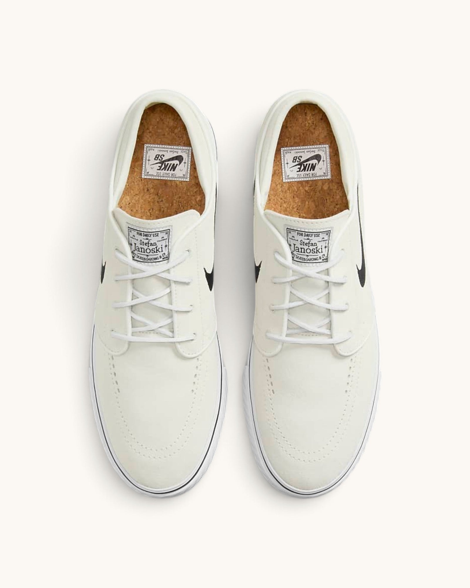 FRIDAY.COM.CO Nike SB Zoom Janoski OG+ skate shoes in off-white suede with black Swoosh and cork insoles, top view