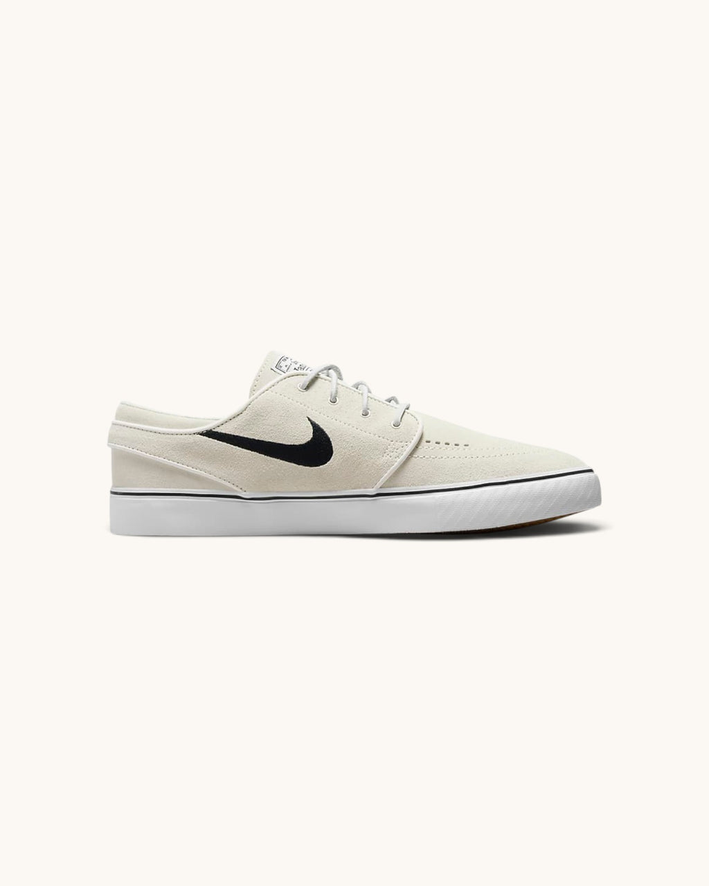 FRIDAY.COM.CO Nike SB Zoom Janoski OG+ skate shoes in off-white suede with a black Swoosh and vulcanized sole.