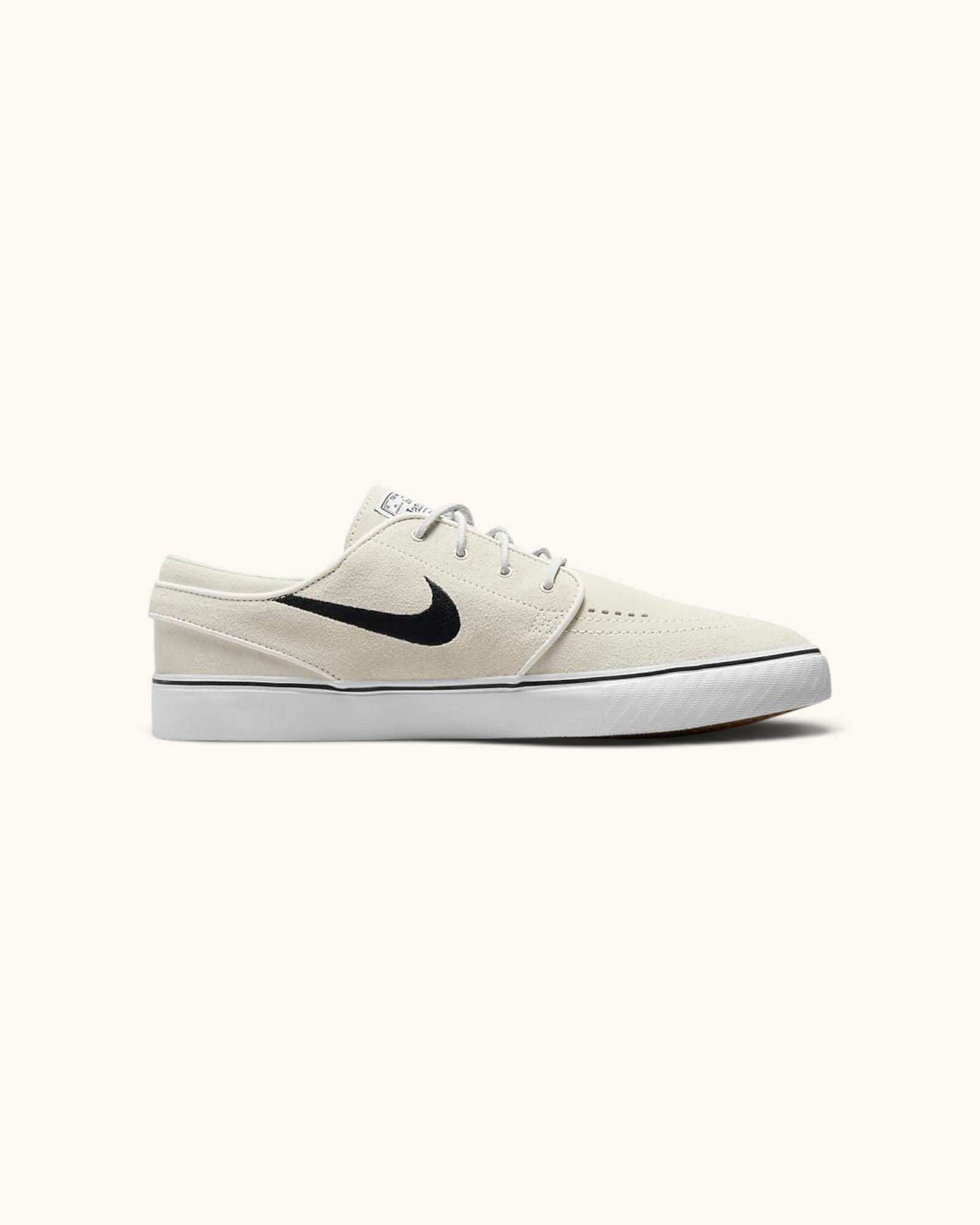 FRIDAY.COM.CO Nike SB Zoom Janoski OG+ skate shoes in off-white suede with a black Swoosh and vulcanized sole.