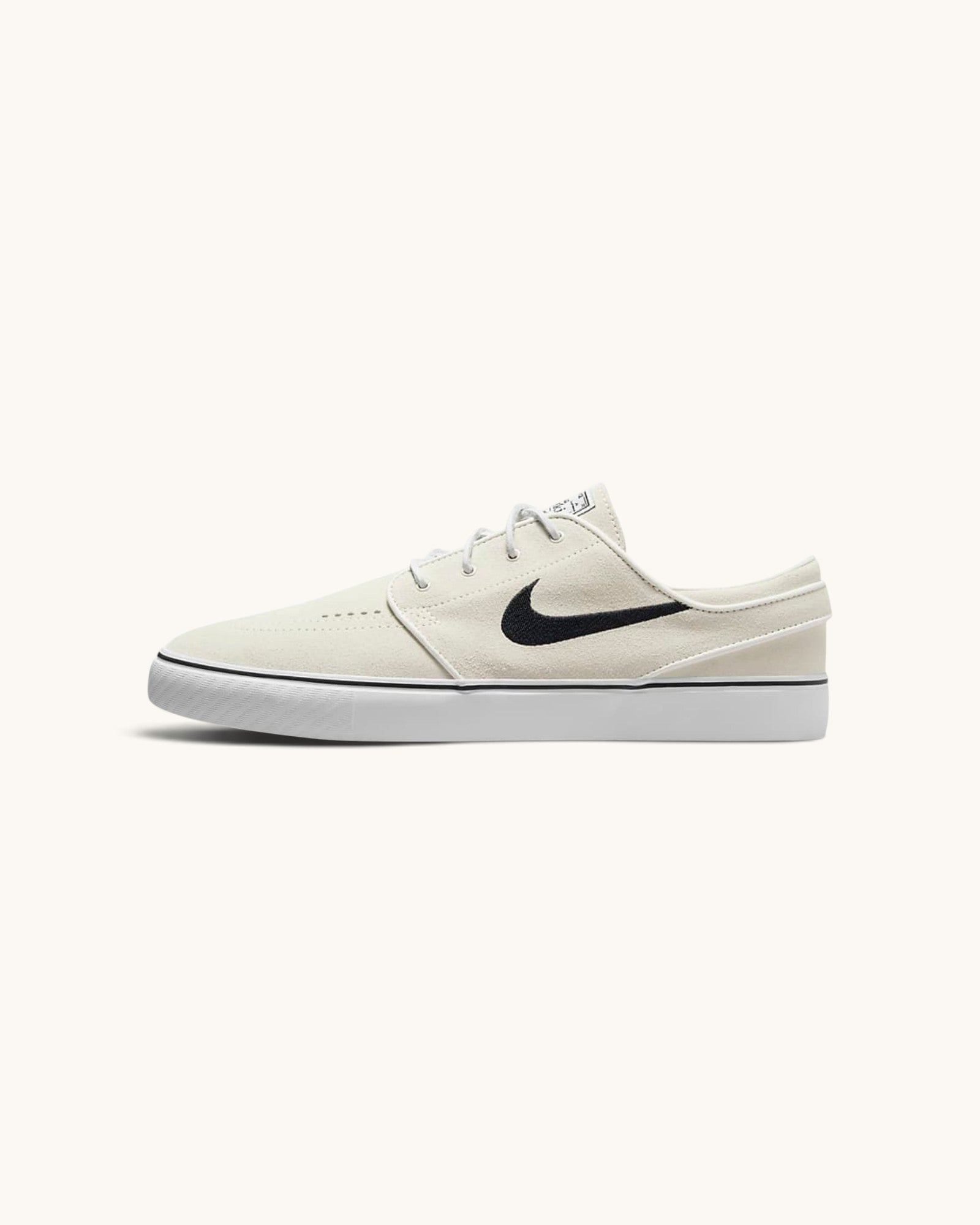FRIDAY.COM.CO Nike SB Zoom Janoski OG+ skate shoes in off-white suede with a black Swoosh and vulcanized sole.